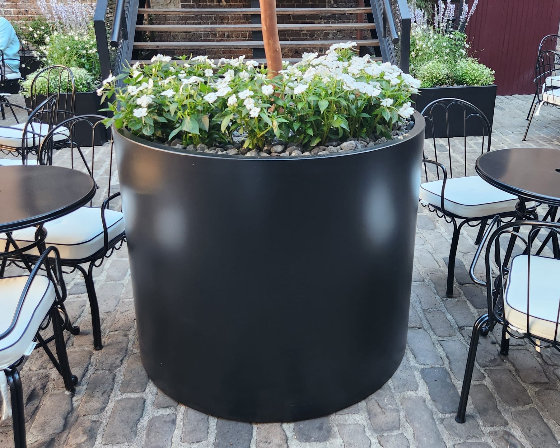 Sculptural aluminium cylinder planters composed in the round