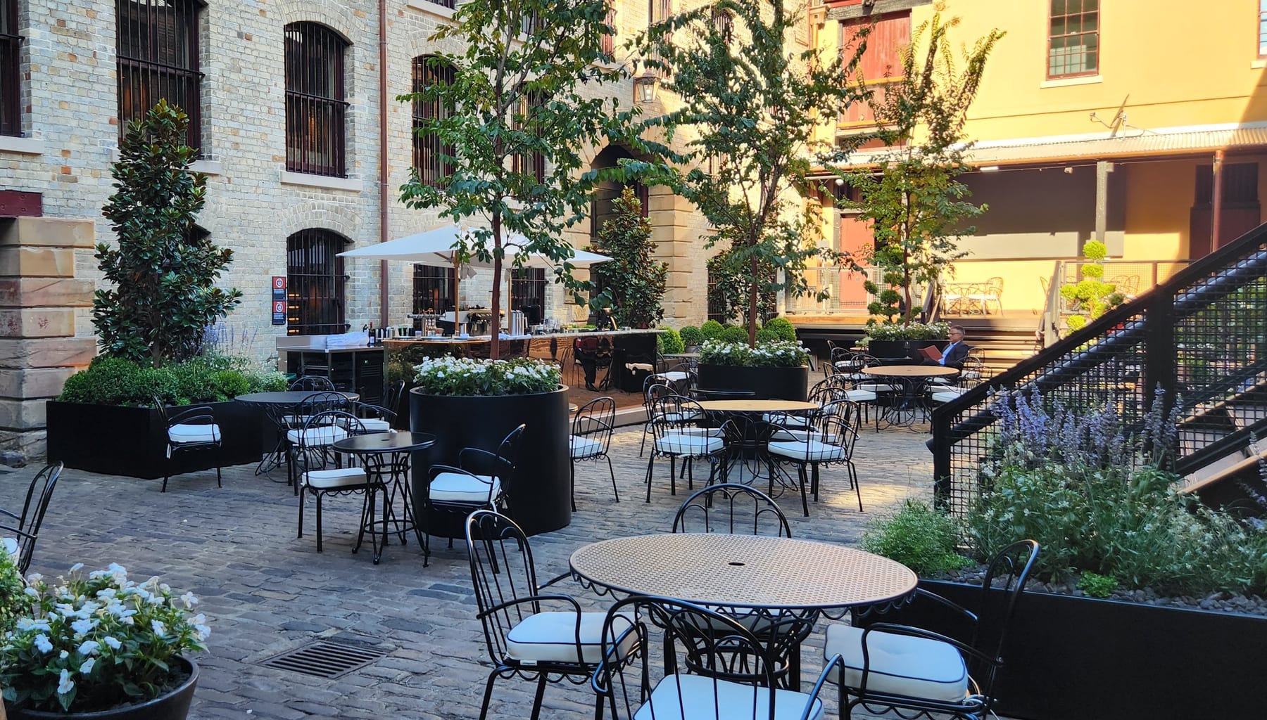 A completed installation of sculptural aluminium cylinder planters