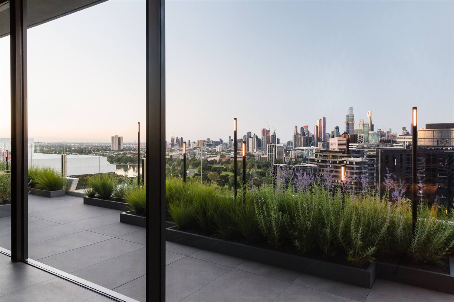 POBOX rooftop planters on a podium overlooking a city skyline at golden hour